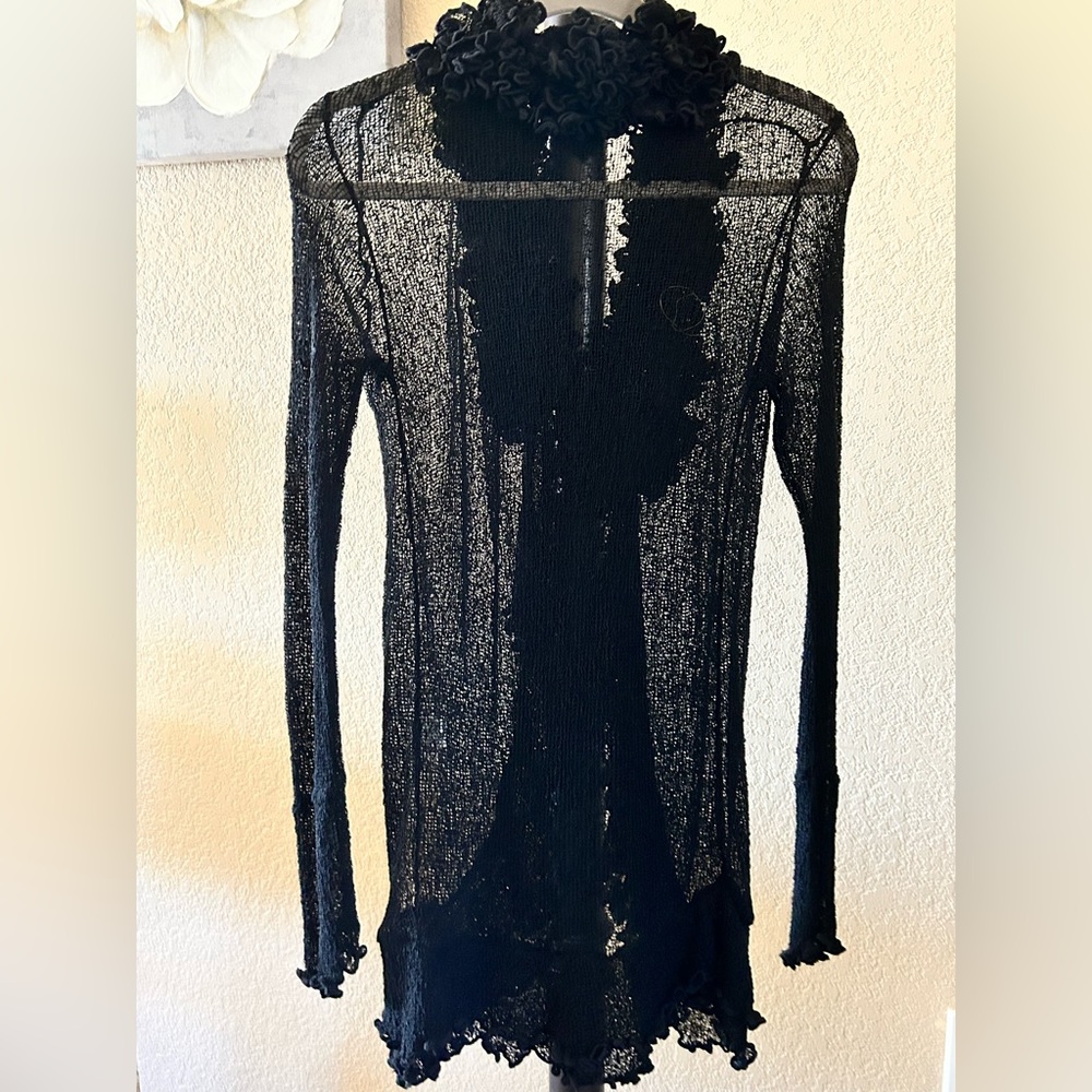 Ladies sheer knee length ruffle sweater.